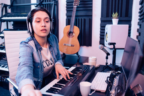 istock Girl playing and composing music in the music studio 1281397811