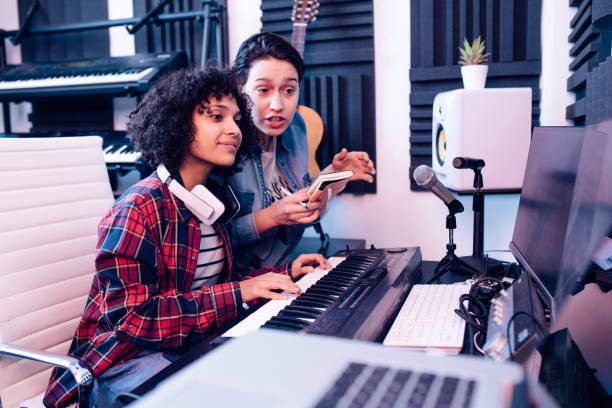 istock Young musicians working together on a new record in the music studio 1281397839