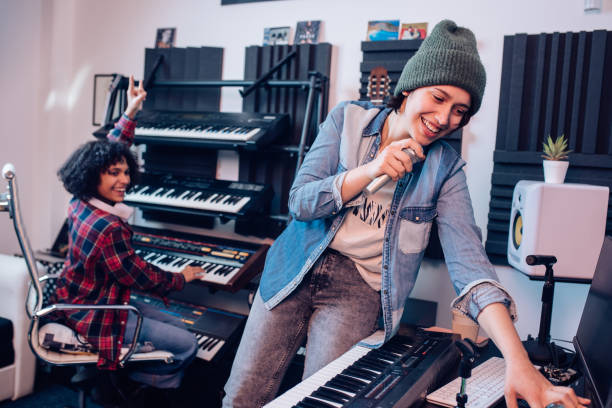 istock Two musicians recording a song and having fun in the studio 1281397863