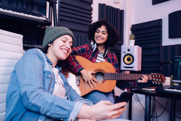 istock Two musicians surfing the net while recording music in the studio 1281397864