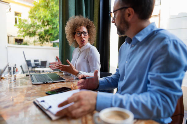 istock Two mature business people discussing about their work at the restaurant 1281398021
