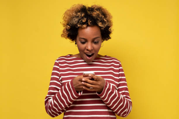 istock Young african woman girl using mobile phone, typing sms message 1281398223