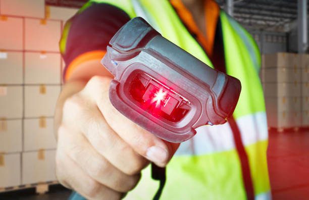 istock Close-up worker scanning barcode scanner with red laser. Computer equipment for warehouse inventory management. 1281399060