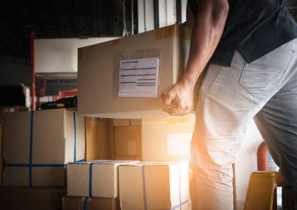 shipment boxes. warehousing storage. worker courier lifting cargo boxes stacking on pallet. - gondola lift imagens e fotografias de stock