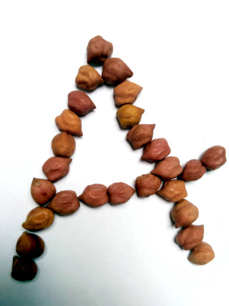 istock The letter 'A' made with Dried black chickpeas on a white background 1281400191