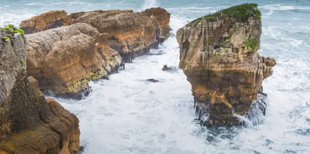 A wide-view shot Pancake Rocks in coastline and beach sea in Punakaiki, South Island, New Zealand.