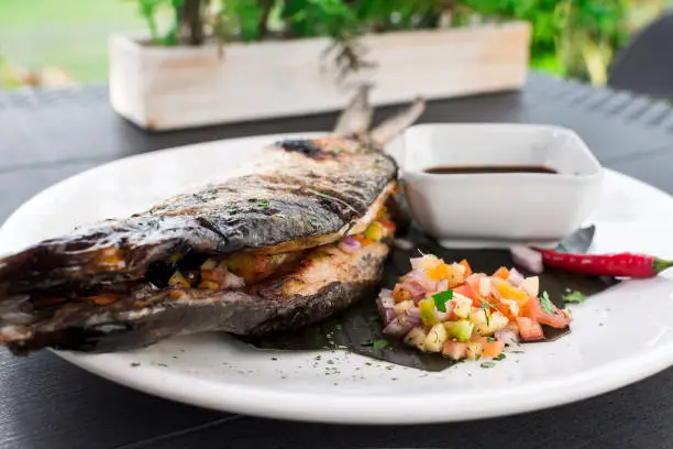 Grilled Boneless Bangus stuffed with vegetables and served with soysauce and Atchara. Bangus is also known as Milkfish.