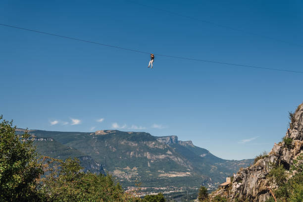 man zip lining von der spitze der bastille - ziplining zip line outdoors zip lining stock-fotos und bilder