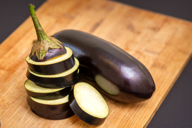 istock Eggplant on wooden cutting board 1281402976
