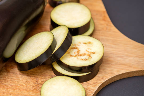 istock Eggplant on wooden cutting board 1281402987