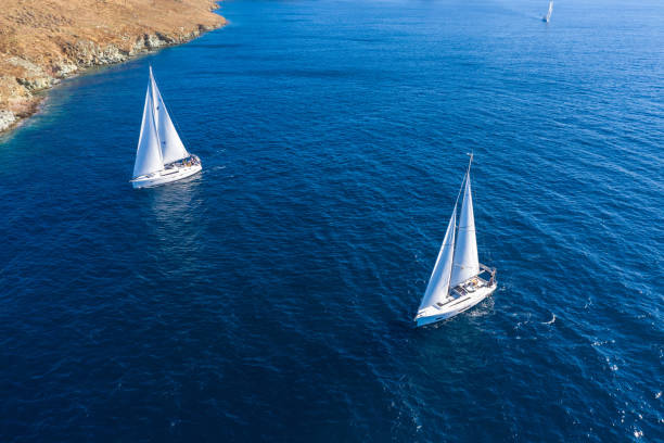 istock Sailing boats with white sails, rippled sea background 1281404047