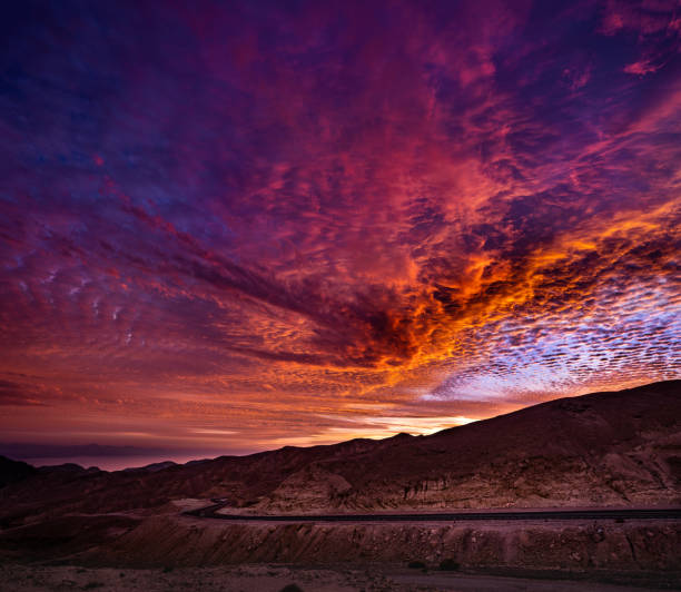 Clouds illuminated bright orange at sunset, Morocco.