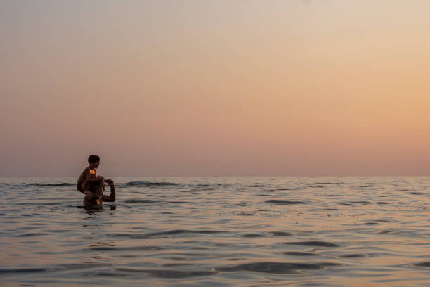 istock The father throws his son into the sea by his shoulder 1281407033