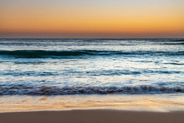 istock Clear skies sunrise seascape with waves 1281408468