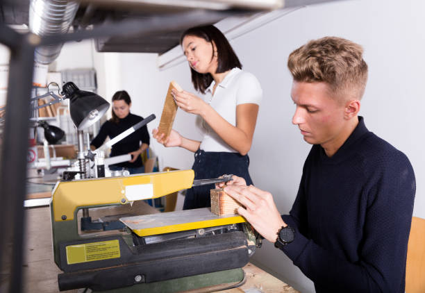 istock Architect making details for architectural model on fretsaw 1281409277