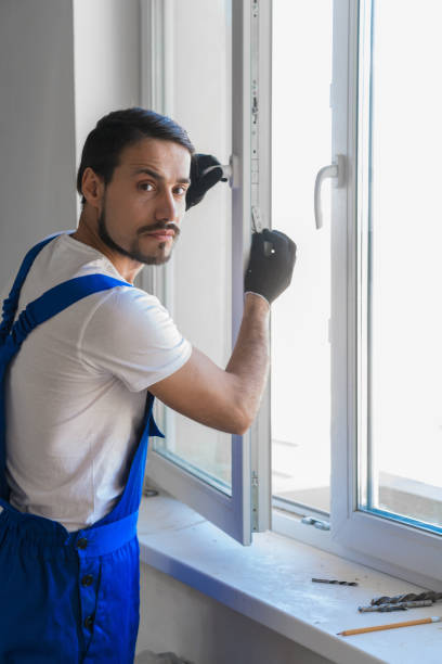 istock Male artisan installs a window in the room 1281410530