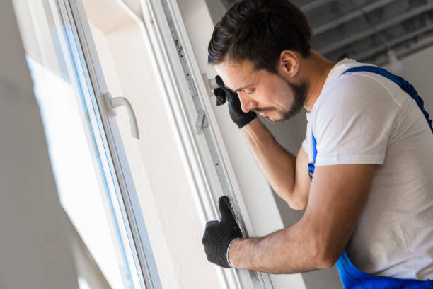istock The builder installs a window frame in the room 1281410534