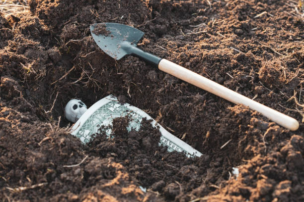 istock bury the dollar and the skeleton under it 1281410890