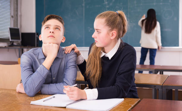 istock Girl student supporting upset friend in classroom 1281412309