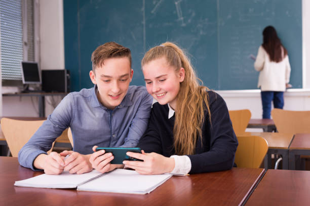 istock Female and male students writing notes together 1281412310