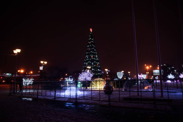 istock snowfall walk down the street past the dressed up festive Christmas tree and colored figures-multi-colored balls 1281413987