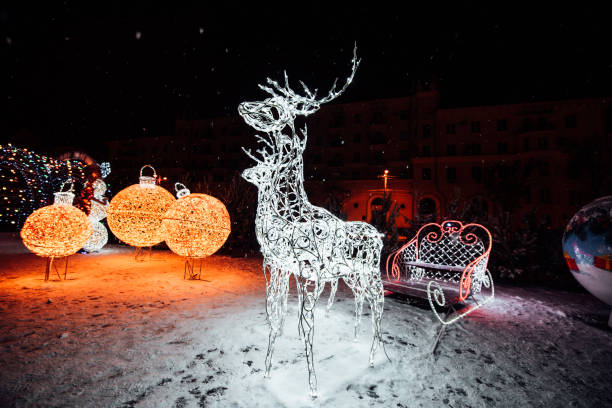 istock Christmas decorations on the street. White Christmas deer. 1281414062