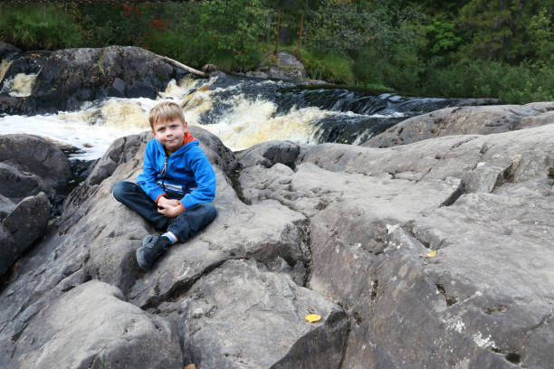 istock Child on background of Ruskeala waterfall 1281414102