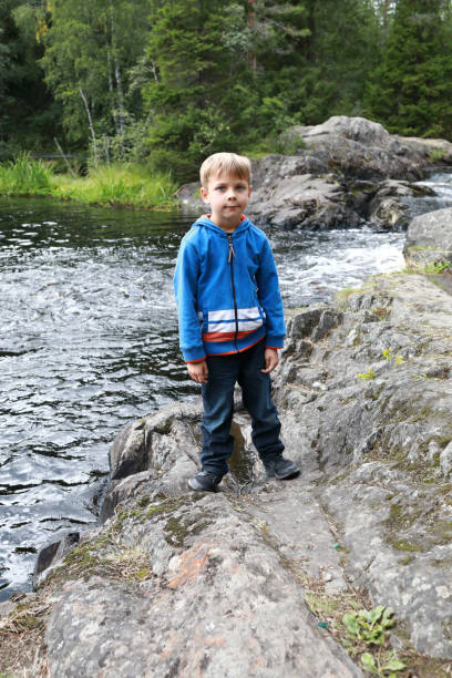 istock Kid on background of Ruskeala waterfall 1281414105