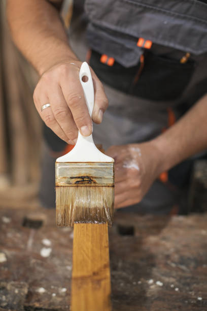 istock Father and daughter painting wooden frame in workshop 1281414787