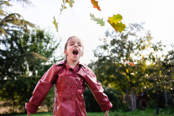 istock Child throws leaves outdoors 1281414789