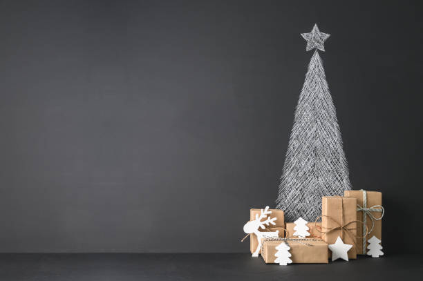 Creative Alternative Christmas tree. Christmas background with chalkboard and presents. stock photo