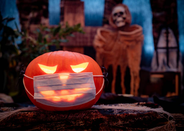 istock Halloween Scene with a Pumpkin Coronavirus Facemask 1281416291