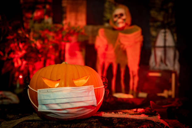 istock Halloween Scene with a Pumpkin Coronavirus Facemask 1281416364