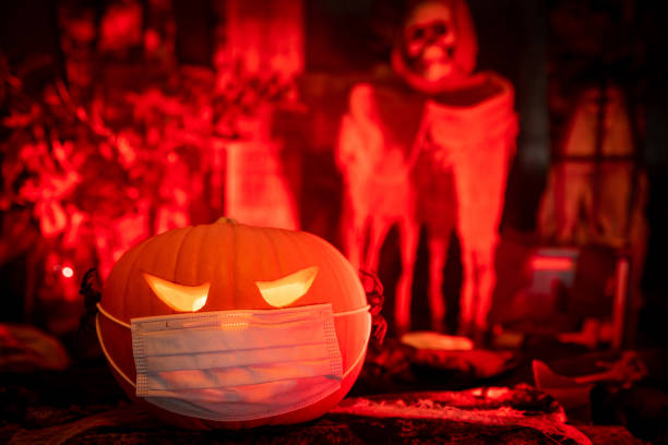 istock Halloween Scene with a Pumpkin Coronavirus Facemask 1281416368