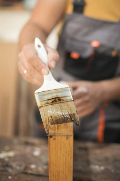 istock Father and daughter painting wooden frame in workshop 1281416909