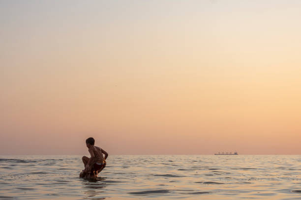 istock The father throws his son into the sea by his shoulder 1281417874
