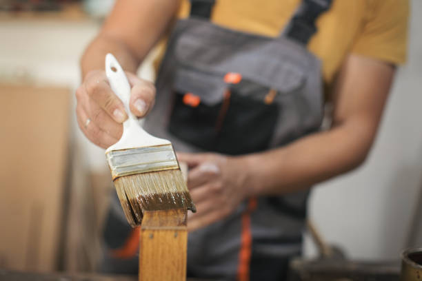 istock Father and daughter painting wooden frame in workshop 1281417965