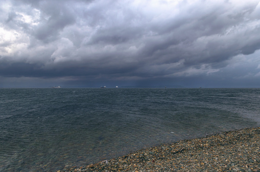 stormy skies over japanese sea with moored ships in Vladivostok