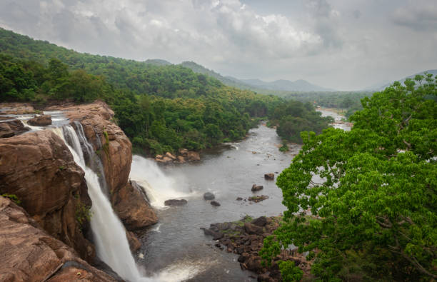 istock waterfall with cloudy sky and green forests of western ghat range 1281421590