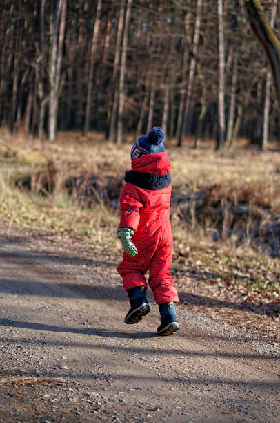 istock 4-5 years old boy on a walk in the winter forest during Coronavirus restrictions 1281421824