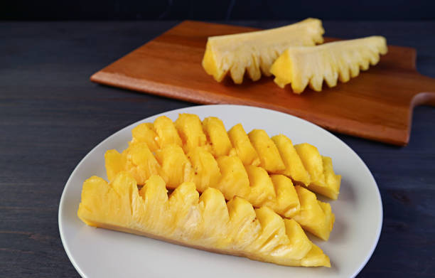 Slices of fresh ripe pineapple in a white plate ready to serve