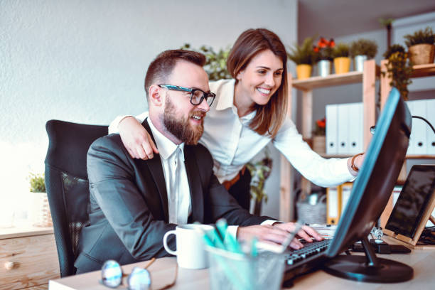 istock Cute Business Couple Working Together On New Project 1281423267