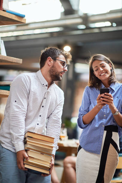 istock Young couple picked too much books at a cafe 1281423934