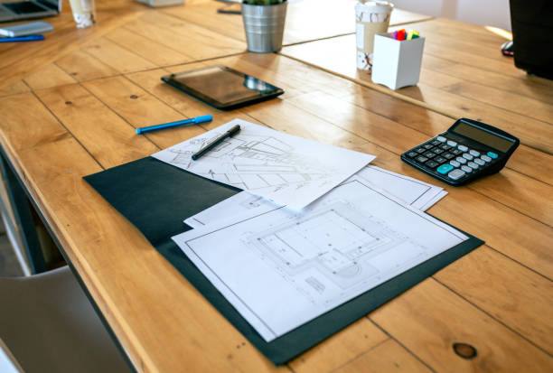 istock Workplace of an architect with blueprints and sketches 1281424921