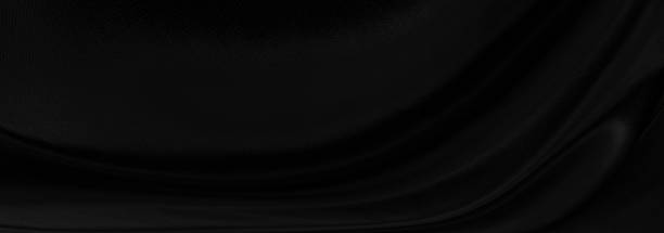 istock Black gray satin dark fabric texture luxurious shiny that is abstract silk cloth panorama background with patterns soft waves blur beautiful. 1281425069