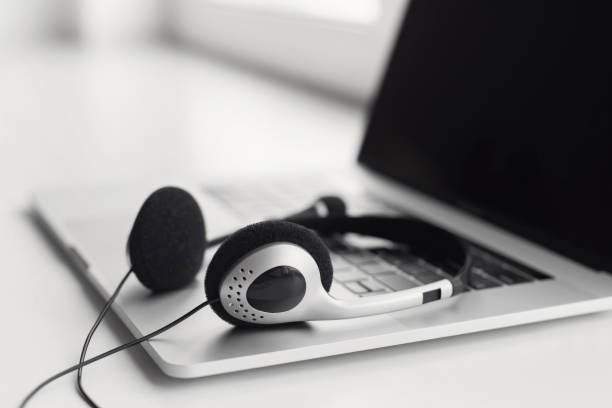istock Place of work. Laptop with headset at desk 1281425552