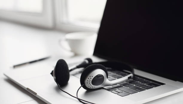 istock Place of work. Laptop with headset at desk 1281425555