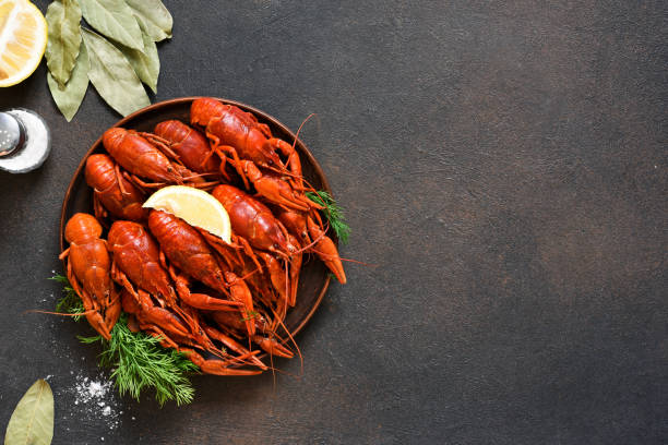 istock Red crayfish with dill, bay leaf and lemon in a plate. 1281426375