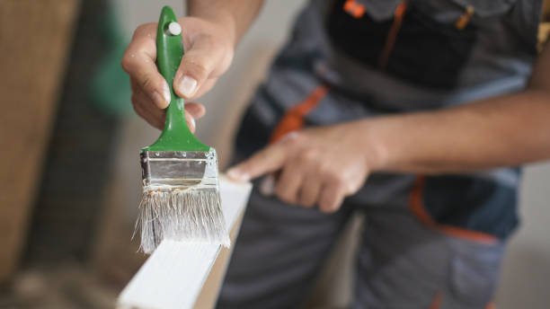 istock Father and daughter painting wooden frame in workshop 1281426467
