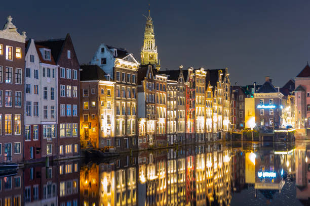 istock Amsterdam Damrak traditional Dutch architecture at night 1281426551